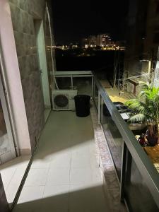 a balcony with a view of a city at night at Elzo Crib !!! in Dakar