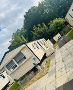a house that is sitting on the side of the road at Vinchella-3 bedroom caravan in Grange Over Sands