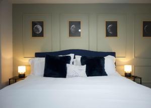 a bedroom with a bed with black and white pillows at LUX NEW! Heated Pool Option, 2Kings, Spa, Old Town, WestWorld, Fashion Square in Scottsdale