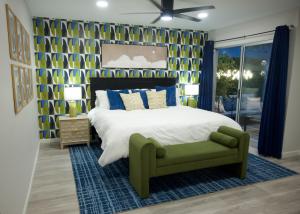 a bedroom with a large bed and a green chair at LUX NEW! Heated Pool Option, 2Kings, Spa, Old Town, WestWorld, Fashion Square in Scottsdale