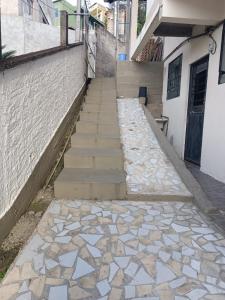 a stone walkway with stairs next to a building at Kitnet Rústica Blumenau in Blumenau