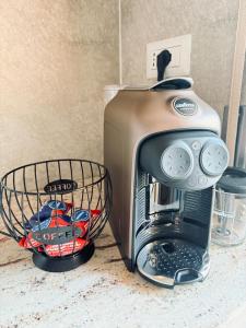 a toaster sitting on a counter next to a basket at O forse il mare apartamento in Marina di Strongoli +17 photos