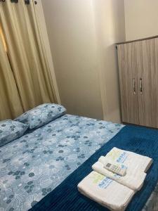 a bedroom with a bed with two towels on it at Casa Mar e Mell in Canguaretama