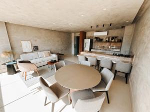 a living room with a table and chairs at Studio Premium Batista Campos in Belém