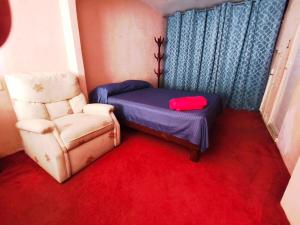 a small room with a bed and a chair at Departamento independiente en Playa sol in Coatzacoalcos