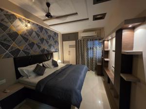 a bedroom with a bed with a blue blanket at Shivalay - By Safarnama Stays - Near Kashi Vishwanath in Varanasi +10 photos