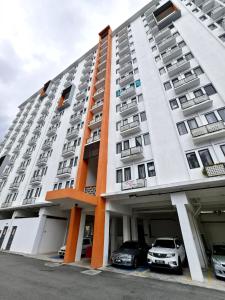 a building with cars parked in front of it at Unisuites Kampar Studio 5 min to UTAR TARC -3pax , 1 CP in Kampar