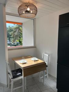 a kitchen with a table and chairs and a window at SEEnah Ferienwohnung in Überlingen