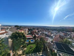 a view of a city from a building at Apartamento con vistas al mar in Viladecáns