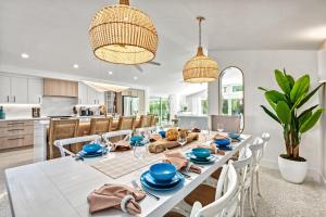 a kitchen and dining room with a white table and chairs at Beach Palm Villa - 5533 in Siesta Key