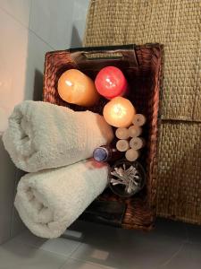 a basket with towels and other items in a bathroom at H&V suite home in Paralía Avlídhos