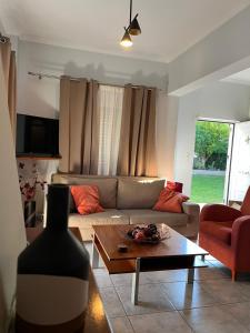 a living room with a couch and a coffee table at H&V suite home in Paralía Avlídhos
