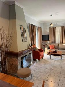a living room with a couch and a fireplace at H&V suite home in Paralía Avlídhos +60 photos