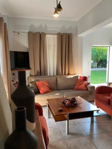 a living room with a couch and a coffee table at H&V suite home in Paralía Avlídhos