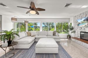 a living room with a couch and a ceiling fan at Siesta Dolce - 3750 in Siesta Key