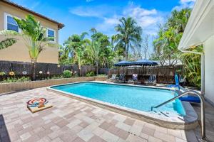 a swimming pool in a yard with chairs and a fence at Siesta Dolce - 3750 in Siesta Key
