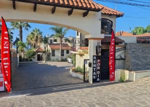 a building with red flags in front of a street at Puerto Nuevo Surf Villa Margarita 2BR with pool in Raulis