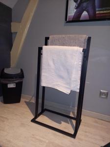a towel hanging on a chair in a room at Loue chambre in Le Mans