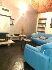 a living room with a blue couch and a tv at Mediterranium in Loano