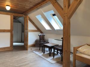 a room with a table and chairs in a attic at Ferienhaus in Neu Poserin for 5 Personen in Neu Poserin