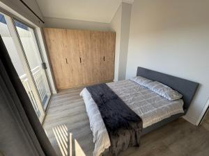 a bedroom with a bed and a large window at Townhouse in Stellenbosch in Stellenbosch
