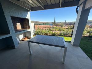 a picnic table sitting on a patio with a view at Townhouse in Stellenbosch in Stellenbosch