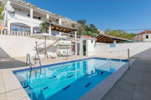 a villa with a swimming pool and a house at Villa Leo in Krilo
