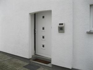eine Tür zu einem Gebäude mit einer Uhr darauf in der Unterkunft Uhler Holiday Apartment in Uhler