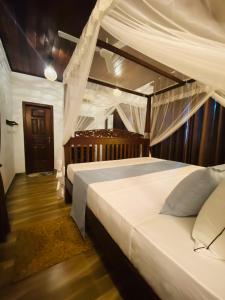 Ένα ή περισσότερα κρεβάτια σε δωμάτιο στο Sea Turtles Bungalow
