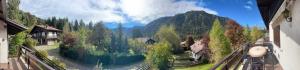 a view of a mountain from a balcony of a house at Wood & Fire Chalet in Borno