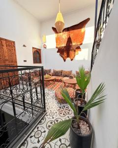 a room with a balcony with potted plants at Dar Skouri 51 in Marrakesh