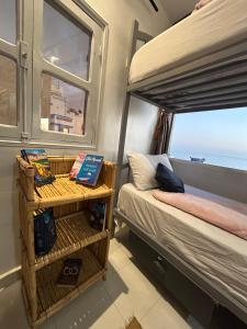 a bedroom with a bunk bed and a window at Ami D'or Hostel in Taghazout +55 photos
