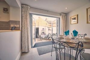 a kitchen and dining room with a table and chairs at Roselyn By The Sea - Pet Friendly Accommodation in Newbiggin-by-the-Sea