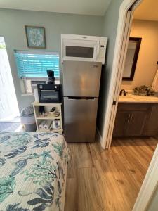 a small kitchen with a refrigerator and a sink at Sea Urchin - Amazing Private Suite Large Bath 3.3mi 2 Beach in Bonita Springs +8 photos