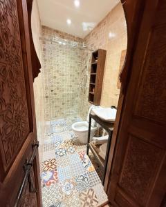 a bathroom with a shower and a toilet and a sink at Dar Skouri 51 in Marrakesh