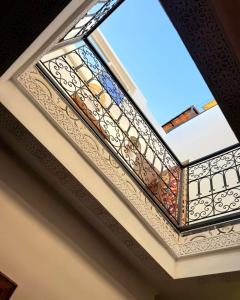 a stained glass window on the ceiling of a building at Dar Skouri 51 in Marrakesh +34 photos