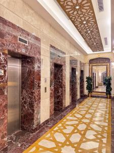 a hallway of a hotel with a tile floor at فندق رفاهية العزيزية in Al ‘Azīzīyah