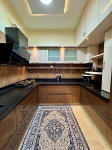 a kitchen with a sink and a counter with a rug at Ultra Luxurious 4 BHK VILLA in Bengaluru