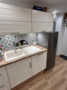 a kitchen with a sink and a refrigerator at Ferienwohnung Südtondern in Uphusum