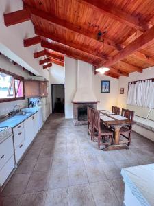 a kitchen with a table and a fireplace at Casa Pier Giorgio Bella Vista in El Chalten