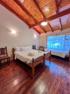 a bedroom with a large bed and a window at Casa Pier Giorgio Bella Vista in El Chalten +16 photos