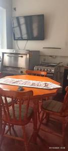 a wooden table with two chairs in a kitchen at alojamiento a pasos del casino dreams y zona gourmet in Punta Arenas