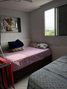 En eller flere senge i et værelse på Lindo apartamento perto de Itu