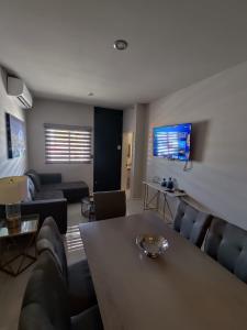 a living room with a couch and a table at A beautiful apartment, in the heart of the golden zone! in Mazatlán