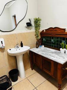 a bathroom with a sink and a mirror at Rest in the Village in Wilderness