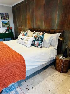 a bed with pillows on it in a bedroom at Rest in the Village in Wilderness