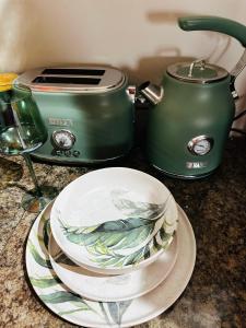 a counter top with a toaster and a plate on a counter at Rest in the Village in Wilderness