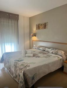 a bedroom with a bed and a window at Hotel Cosmos Tarragona in Tarragona