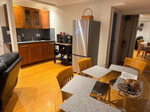 a kitchen and living room with a table and a refrigerator at Place near the Coquitlam River Park in Coquitlam