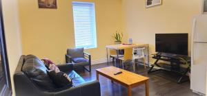 a living room with a couch and a flat screen tv at Perfect Location! Quiet-Spacious-2 Bed-2 Bath in Windsor